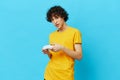 man yellow T-shirt with joystick video games technologies