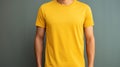 Man in yellow t shirt mockup template for design print studio shot on light gray wall