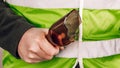 Man in a yellow vest protesting with a broken bottle in his hands