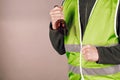 Man in a yellow vest protesting with a broken bottle in his hands