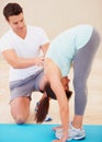 Man, yoga and personal trainer with young woman stretching body for fitness, exercise or workout at gym. Male yogi Royalty Free Stock Photo