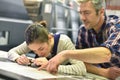 Man and young apprentice checking on print quality Royalty Free Stock Photo