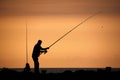 Silhouette of a Father and son fishing at sunset Royalty Free Stock Photo