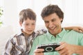 Man and young boy with handheld game