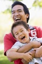 Man and young boy outdoors embracing and smiling Royalty Free Stock Photo