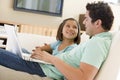 Man with young girl in living room with laptop Royalty Free Stock Photo