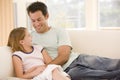 Man and young girl in living room smiling Royalty Free Stock Photo