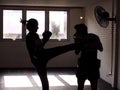 Man and young woman fighting together. Female practicing boxing. Fit woman and her trainer boxing indoors. Portrait of young Royalty Free Stock Photo