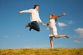 Man and young woman jumping Royalty Free Stock Photo