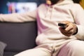 Man zapping through TV channels using remote, close up shot