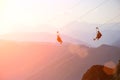 Man on zip line. extreme sport in mountains at the sunset Royalty Free Stock Photo