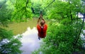 A man ziplining across a river in the summer