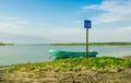 MANABI, ECUADOR, MAY, 29, 2018 Outdoor view of fishing boat in the shore and informative sign of snorkeling area allow