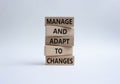 Manage and Adapt to Changes symbol. Wooden blocks with words Manage and Adapt to Changes. Beautiful white background. Business and Royalty Free Stock Photo