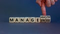 Manage stress and be health symbol. Doctor turns cubes and changes words `manage stress` to `manage health`. Beautiful grey