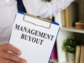 Management Buyout MBO papers with clipboard in the room. Royalty Free Stock Photo