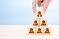 Management hierarchy pyramid with wooden cubes. Human resources, corporate hierarchy concept and multilevel marketing - recruiter Royalty Free Stock Photo