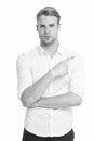 Manager or assistant help find direction. Pointing direction. Man shop assistant pointing index finger isolated on white