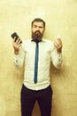 Manager or bearded man compare mobile phone and smartphone Royalty Free Stock Photo