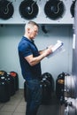 Manager of brewery inspecting equipment producing craft beer