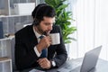 Manager of call center operator office sitting on his desk with coffee. fervent Royalty Free Stock Photo