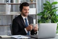 Manager of call center operator office sitting on his desk with coffee. fervent Royalty Free Stock Photo