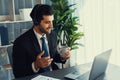 Manager of call center operator office sitting on his desk with coffee. fervent Royalty Free Stock Photo