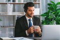 Manager of call center operator office sitting on his desk with coffee. fervent Royalty Free Stock Photo