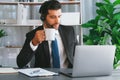 Manager of call center operator office sitting on his desk with coffee. fervent Royalty Free Stock Photo