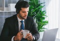 Manager of call center operator office sitting on his desk with coffee. fervent Royalty Free Stock Photo