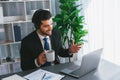 Manager of call center operator office sitting on his desk with coffee. fervent Royalty Free Stock Photo