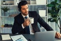 Manager of call center operator office sitting on his desk with coffee. fervent Royalty Free Stock Photo