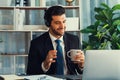 Manager of call center operator office sitting on his desk with coffee. fervent Royalty Free Stock Photo