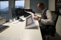 Manager - Caucasian male in his office sitting behind the desk looking at the files Royalty Free Stock Photo