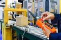 Manager check and control automation cardboard boxes on conveyor belt