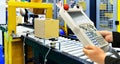 Manager check and control automation cardboard boxes on conveyor belt