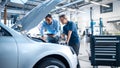 Manager Checks Diagnostics Results on a Tablet Computer and Explains an Engine Breakdown to an Fem Royalty Free Stock Photo