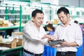 Manager and chinese worker in factory, Managing and cooperation