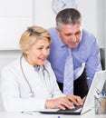 Manager and doctor reading news Royalty Free Stock Photo