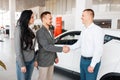 Manager gives the couple a new car in showroom Royalty Free Stock Photo