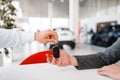 Manager gives woman key to the new car in showroom Royalty Free Stock Photo