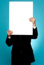 Manager hiding his face behind white banner ad Royalty Free Stock Photo