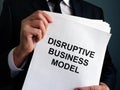 Man is holding Disruptive Business Model report