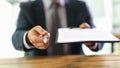 Manager holding out paper document on clipboard and pen for signing closeup Royalty Free Stock Photo