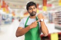 Manager at hypermarket showing wristwatch