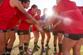 Manager Joining Hands With Womens Soccer Team During Pep Talk Before Match