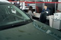 Manager and lady in cardealership sitting at the table Royalty Free Stock Photo