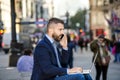 Manager with laptop and smart phone, sunny Piccadilly Circus, Lo Royalty Free Stock Photo