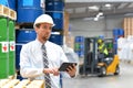 manager in a logistic company work in a warehouse with chemicals - checking goods with tablet Royalty Free Stock Photo