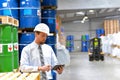 Manager in a logistic company work in a warehouse with chemicals